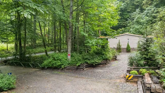 a backyard of a house with lots of green space and fountain in the back