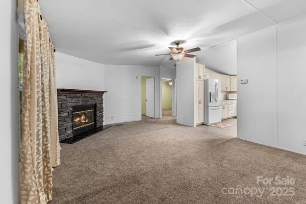 a view of a livingroom with a fireplace and fan
