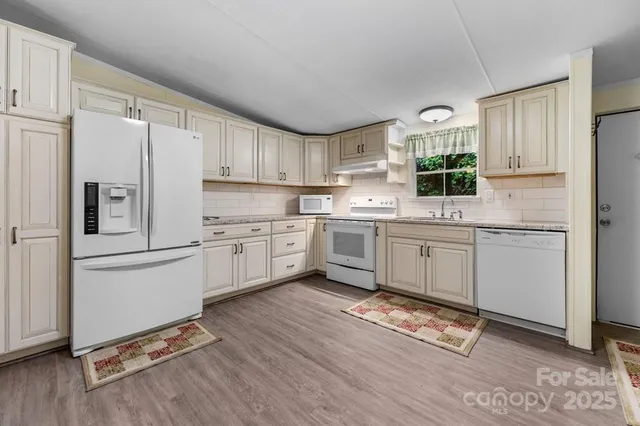 a kitchen with a sink window and cabinets