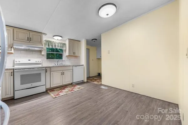 a kitchen with a stove top oven sink and cabinets