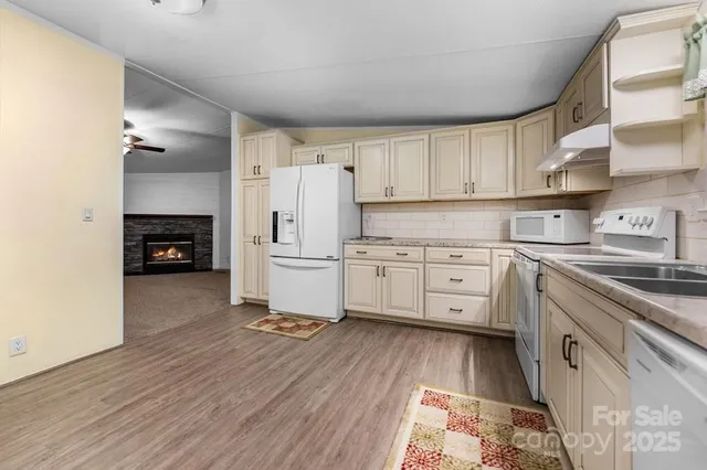 a kitchen with white cabinets and white appliances