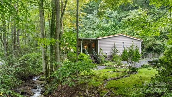 a house with lots of trees in the background