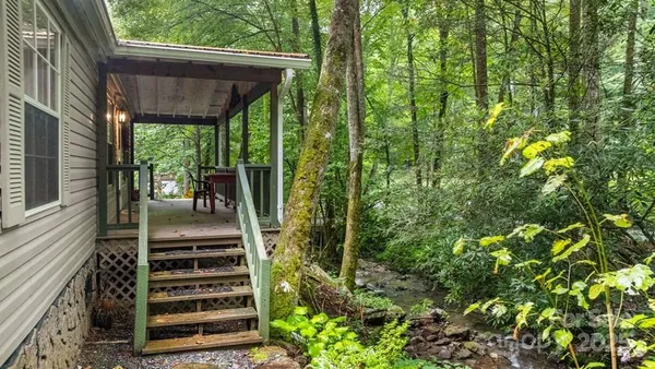 a view of a patio with table and chairs and potted plants