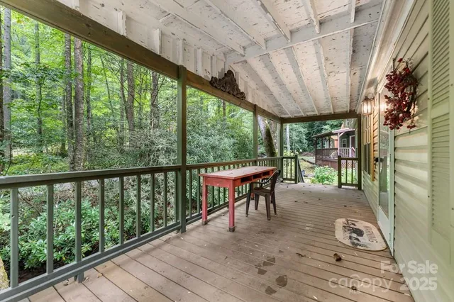 a view of porch with a table chairs and wooden floor