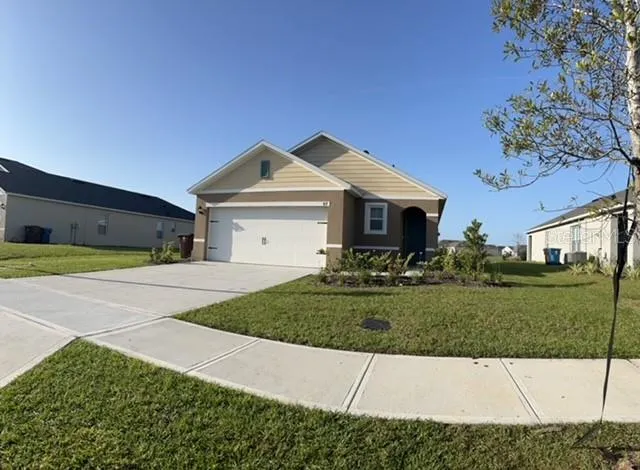 a front view of a house with a yard and garage