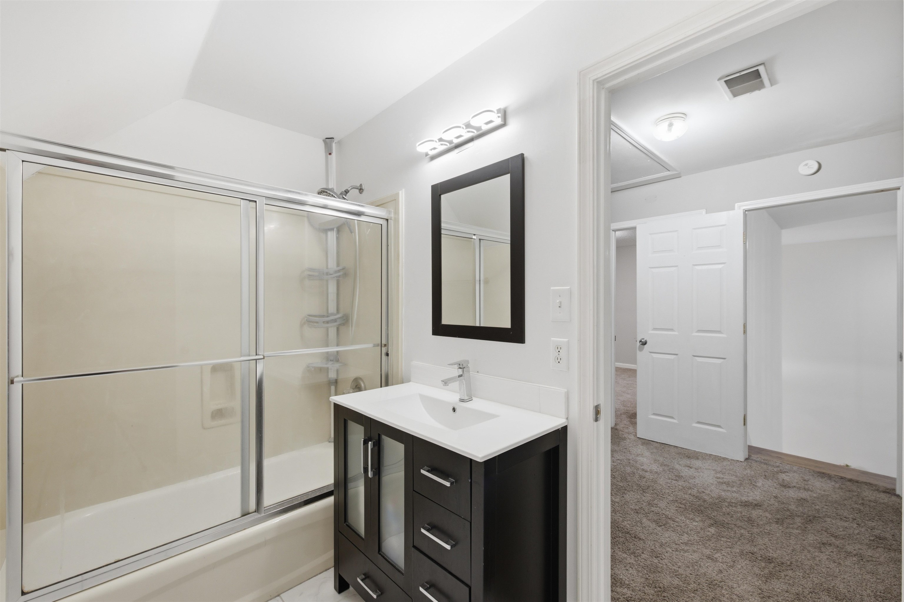 96 Berryfield Cove Collierville, TN 38017 - Photo 24 of 39 Bathroom featuring a dark wood-finish vanity with a white countertop, an integrated sink, and a chrome faucet