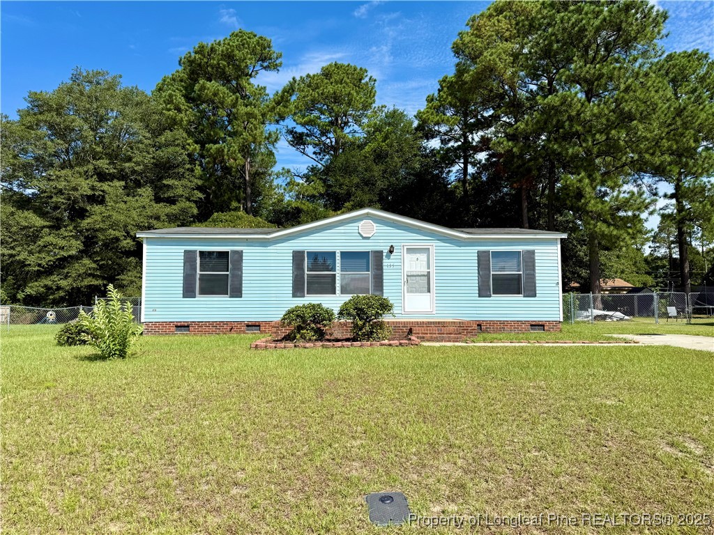 a front view of house with yard and green space