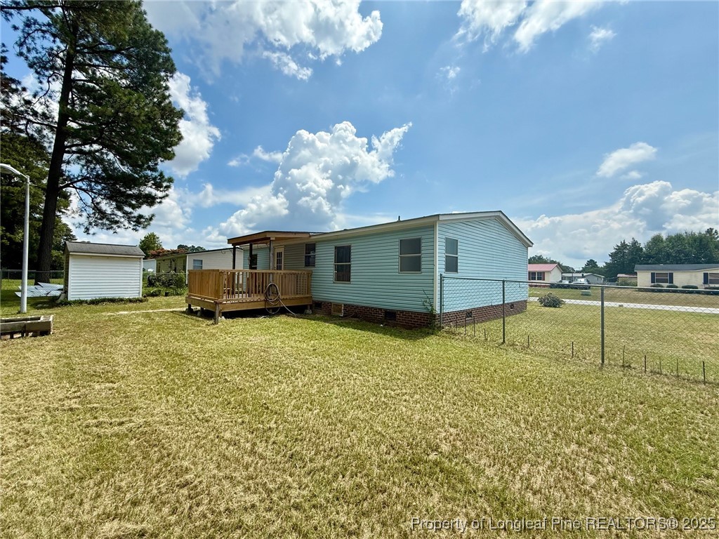 135 Snowhill Church Road Fayetteville, NC 28306 - Photo 13 of 13 a view of a house with a backyard