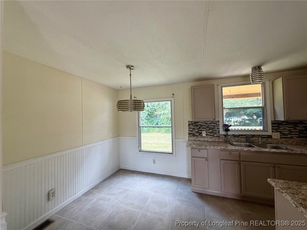 135 Snowhill Church Road Fayetteville, NC 28306 - Photo 4 of 13 a kitchen with stainless steel appliances granite countertop a stove a sink and a window