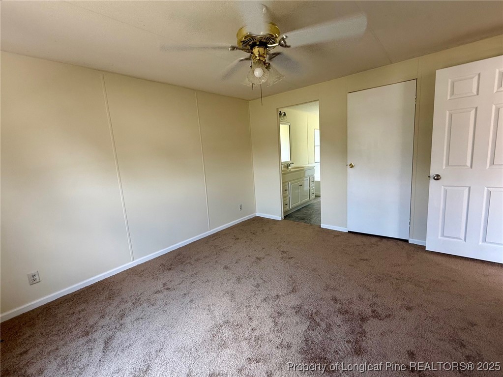 135 Snowhill Church Road Fayetteville, NC 28306 - Photo 5 of 13 an empty room with closet and fan