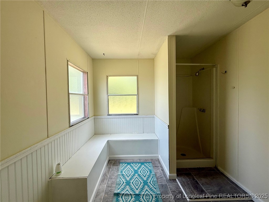 135 Snowhill Church Road Fayetteville, NC 28306 - Photo 6 of 13 a bathroom with a bathtub and shower