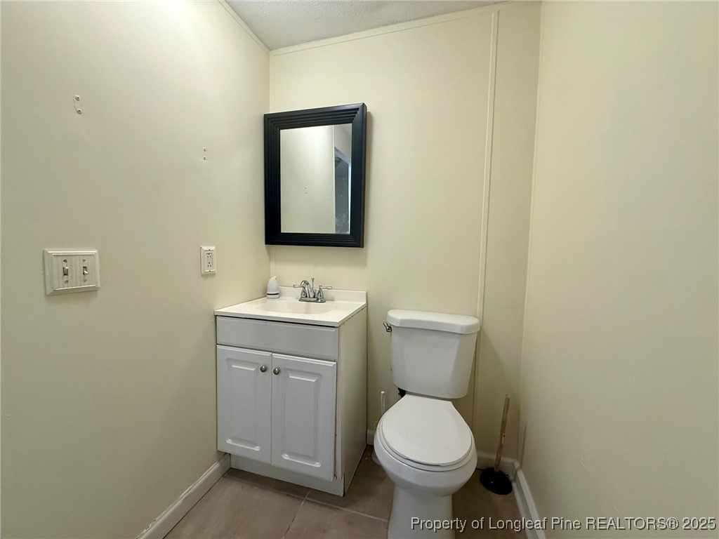 135 Snowhill Church Road Fayetteville, NC 28306 - Photo 9 of 13 a bathroom with a toilet sink and mirror