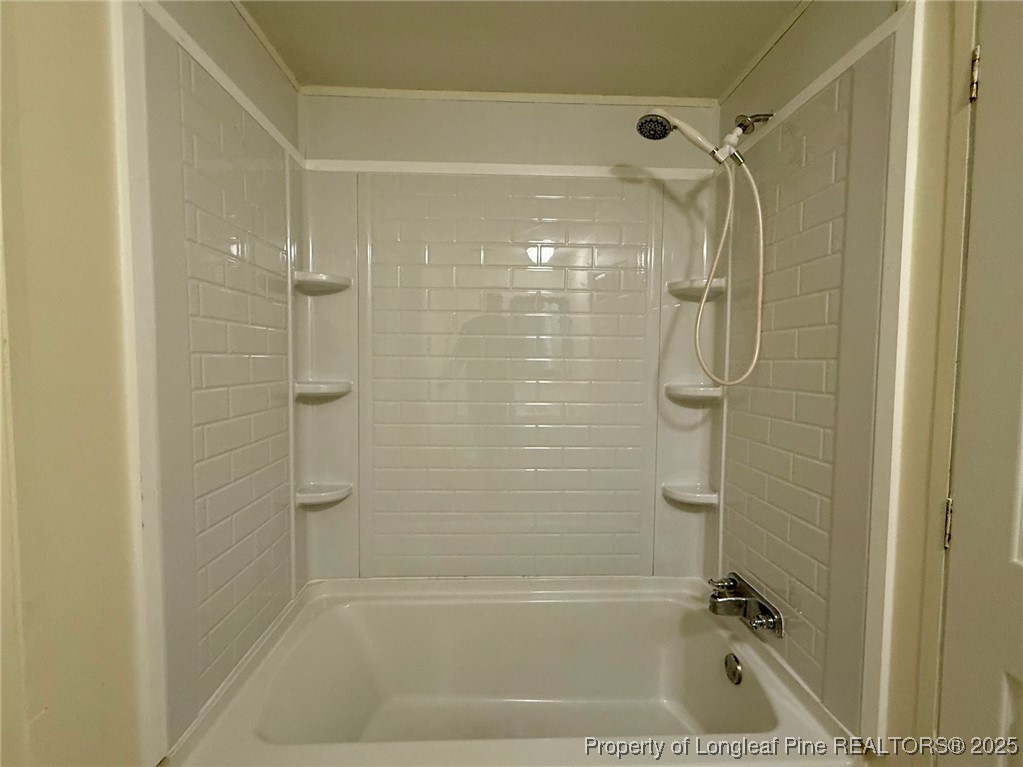 135 Snowhill Church Road Fayetteville, NC 28306 - Photo 10 of 13 a bathroom with a shower and a bath tub