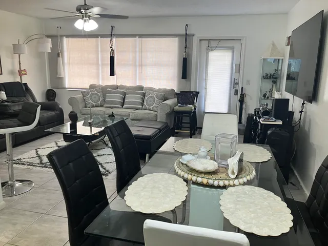 a living room with furniture kitchen and a window