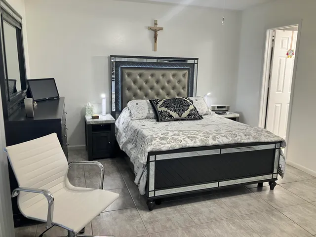 a bedroom with a bed and a dresser