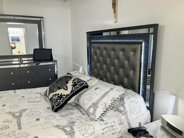 a bedroom with a bed and a television