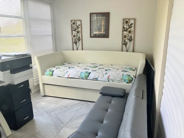 a bedroom with a bed and a couch