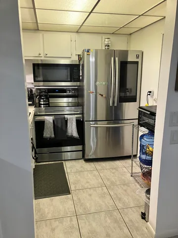 a kitchen with granite countertop a refrigerator and a stove