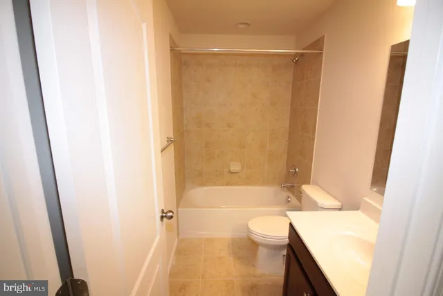 a bathroom with a bathtub shower sink and toilet
