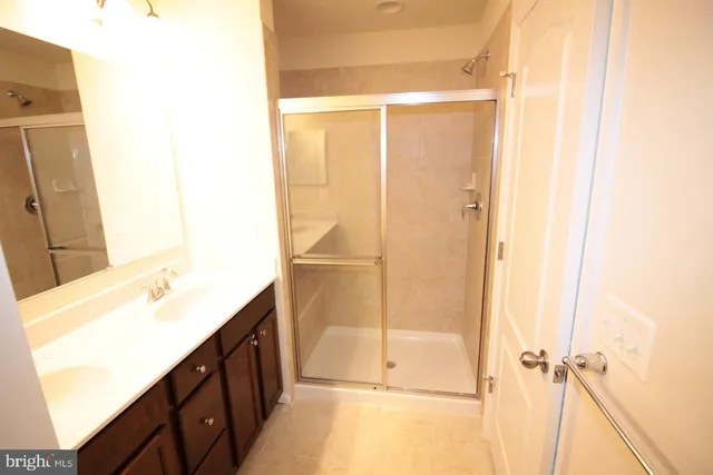 a bathroom with a shower and a sink