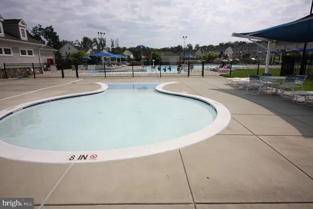 a view of a swimming pool and lounge chair