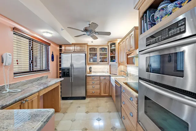 a kitchen with stainless steel appliances granite countertop a sink and cabinets