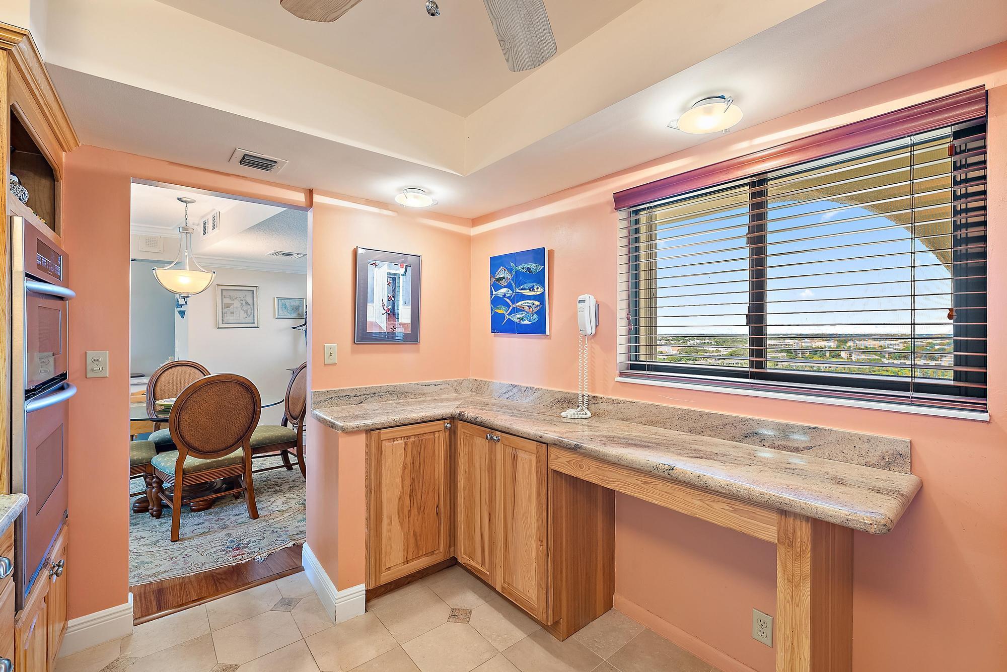 400 Ocean Trail Way, Unit 1409 Jupiter, FL 33477 - Photo 21 of 30 a kitchen with a sink cabinets and dining table