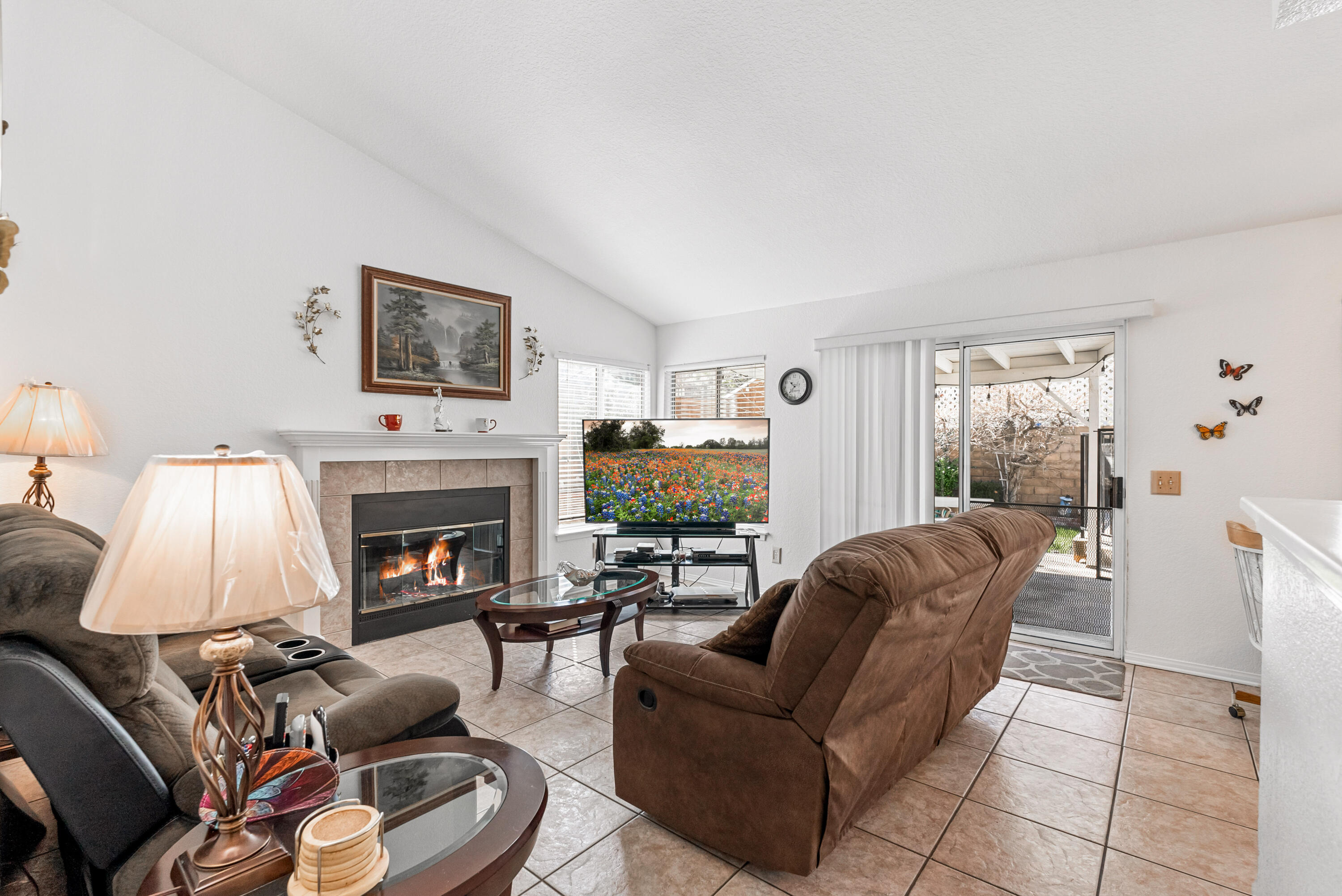 3030 Quarry Road Palmdale, CA 93550 - Photo 11 of 46 a living room with furniture a flat screen tv and a fireplace
