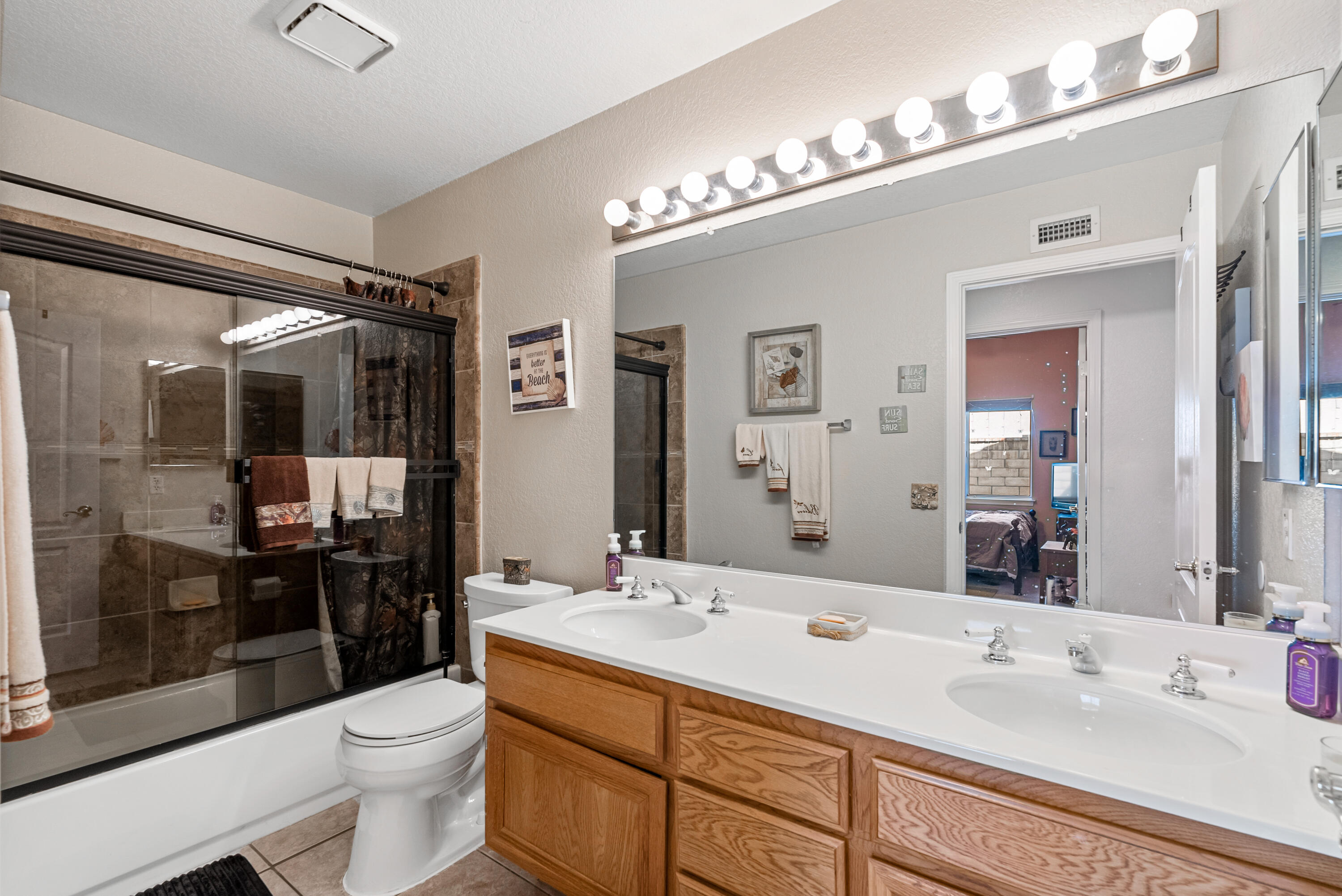 3030 Quarry Road Palmdale, CA 93550 - Photo 32 of 46 a bathroom with a sink double vanity and a mirror