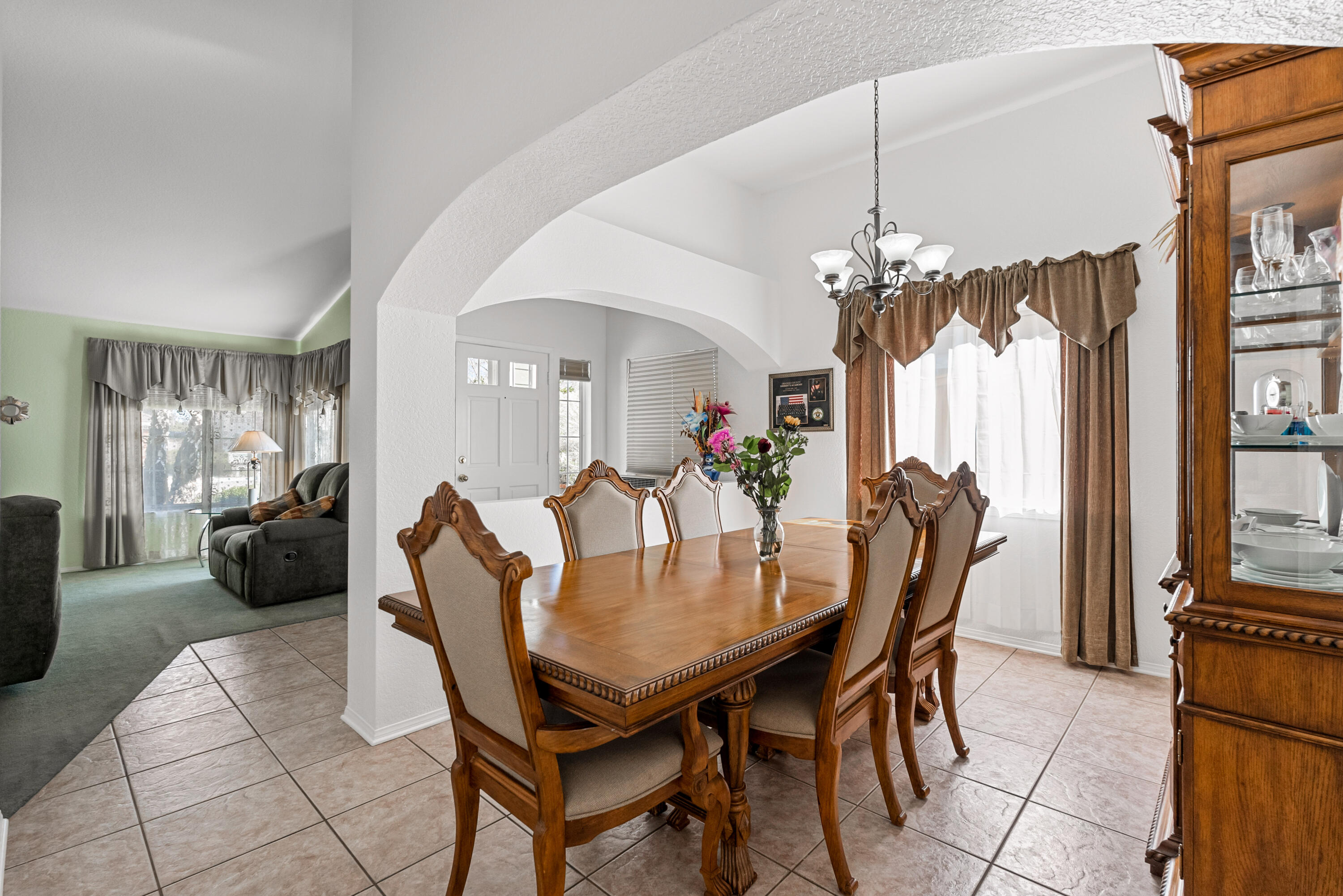 3030 Quarry Road Palmdale, CA 93550 - Photo 9 of 46 a view of a dining room with furniture and a chandelier