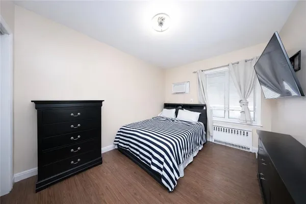 a bedroom with a bed and a dresser