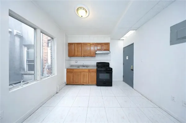 a kitchen with stainless steel appliances a stove top oven and a refrigerator