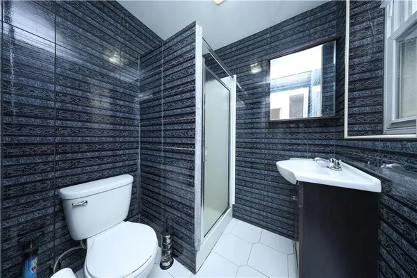 a bathroom with a toilet a sink and mirror