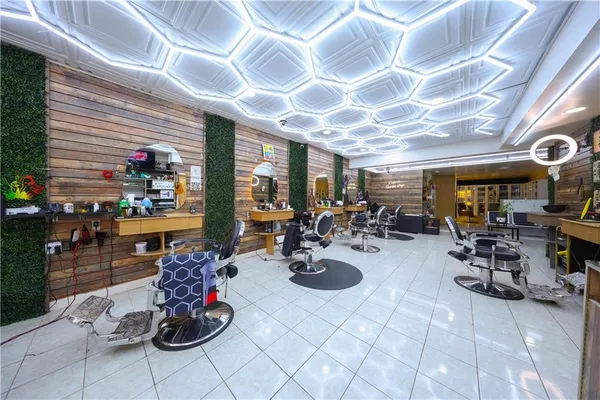 a room with lots of chairs a chandelier and a projector