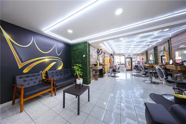 a living room with furniture a rug and white walls
