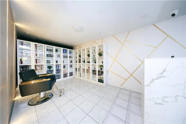 a view of a livingroom with lounge chair and a large window