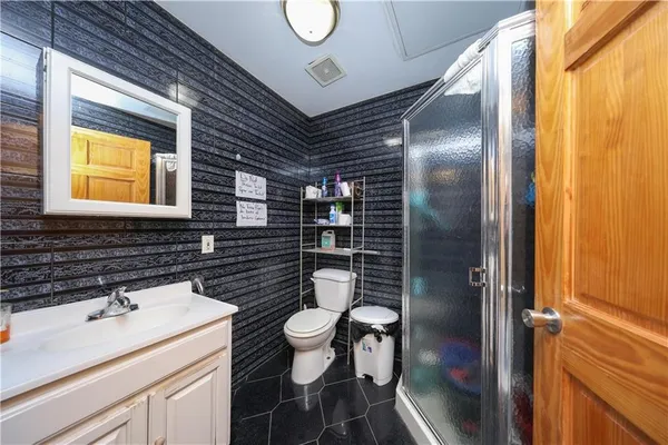 a bathroom with a sink a toilet and shower