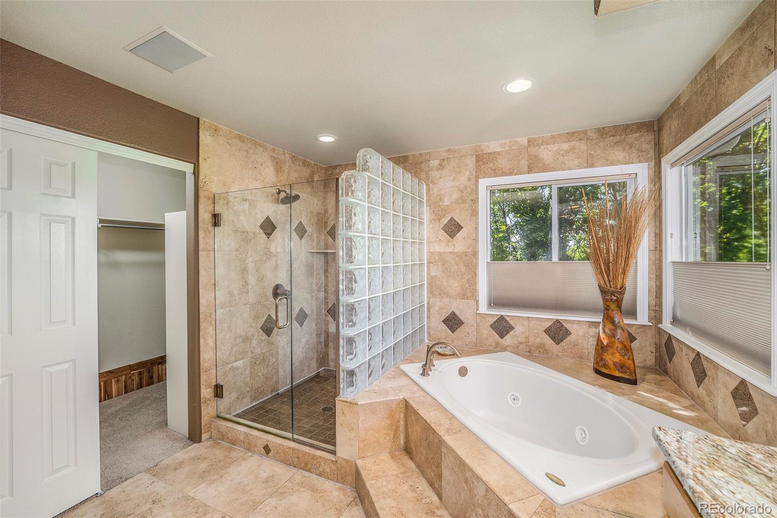 3822 Broadmoor Loop Broomfield, CO 80023 - Photo 26 of 40 a bathroom with a tub sink and shower