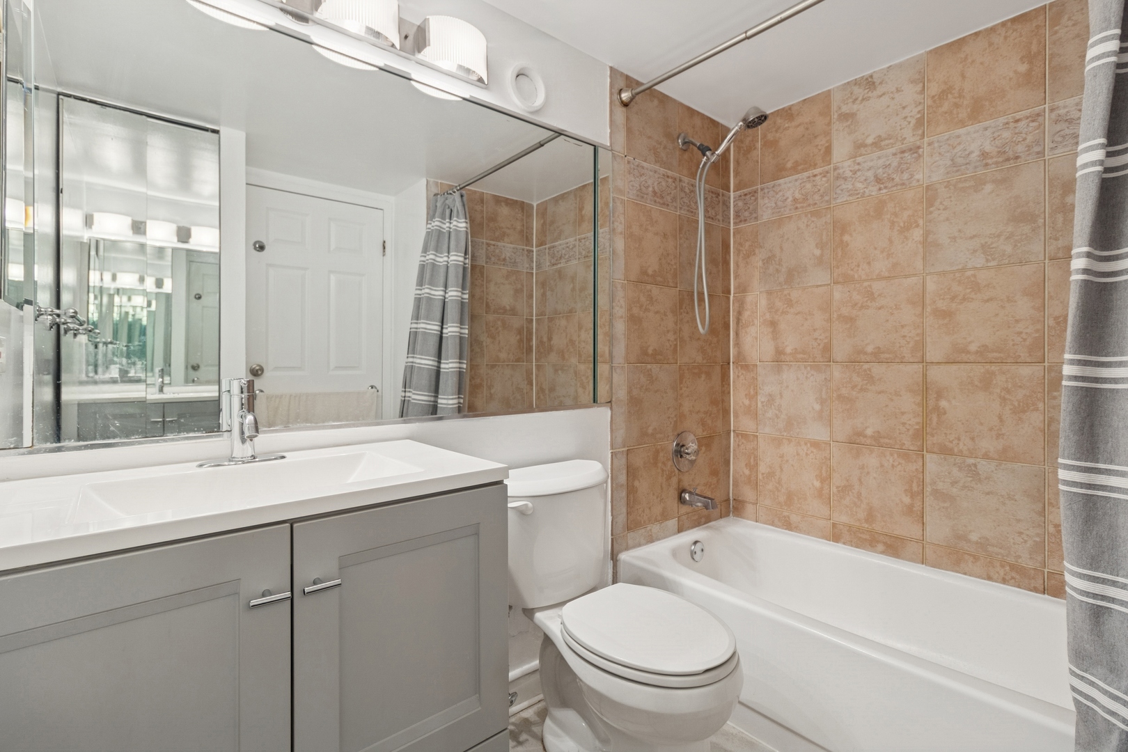 711 West Gordon Terrace, Unit 117 Chicago, IL 60613 - Photo 15 of 20 a bathroom with a sink a toilet and shower