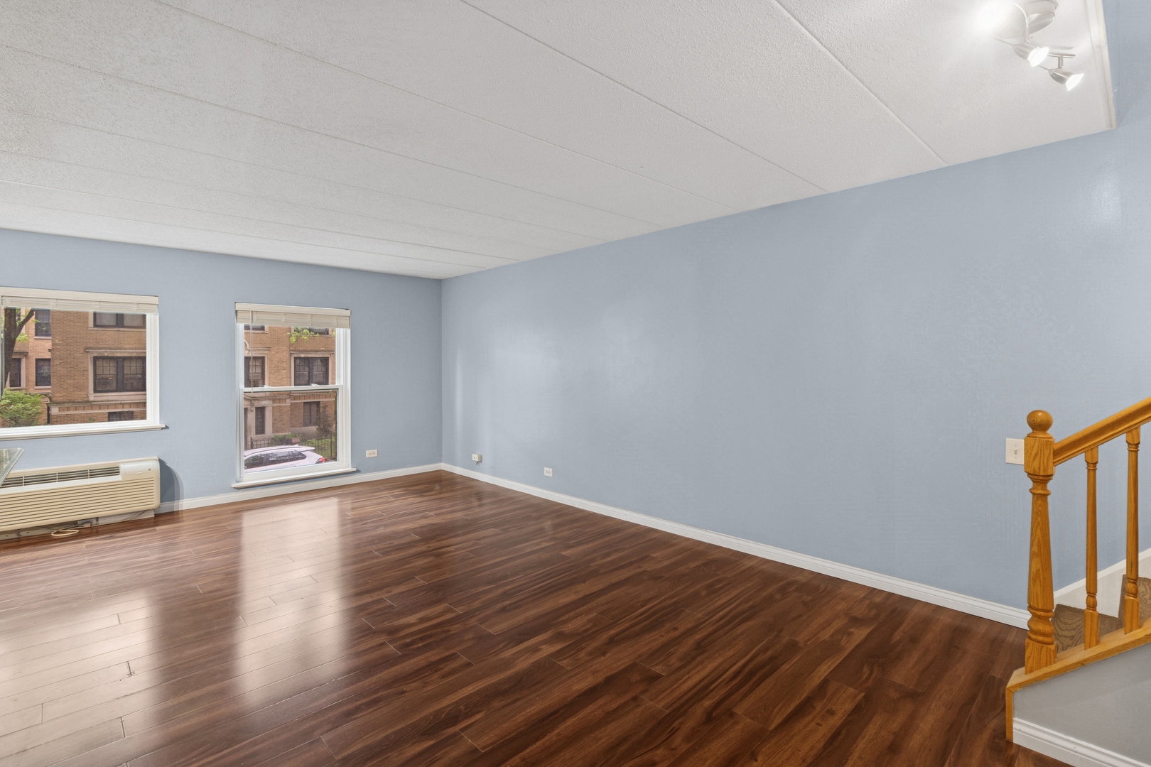711 West Gordon Terrace, Unit 117 Chicago, IL 60613 - Photo 17 of 20 a view of empty room with wooden floor and fan