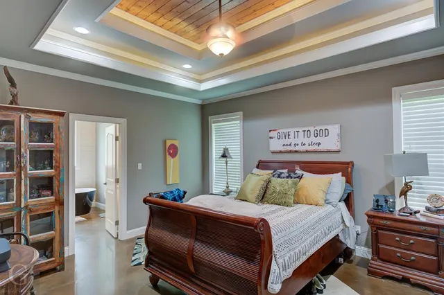 a bedroom with a bed and a chandelier