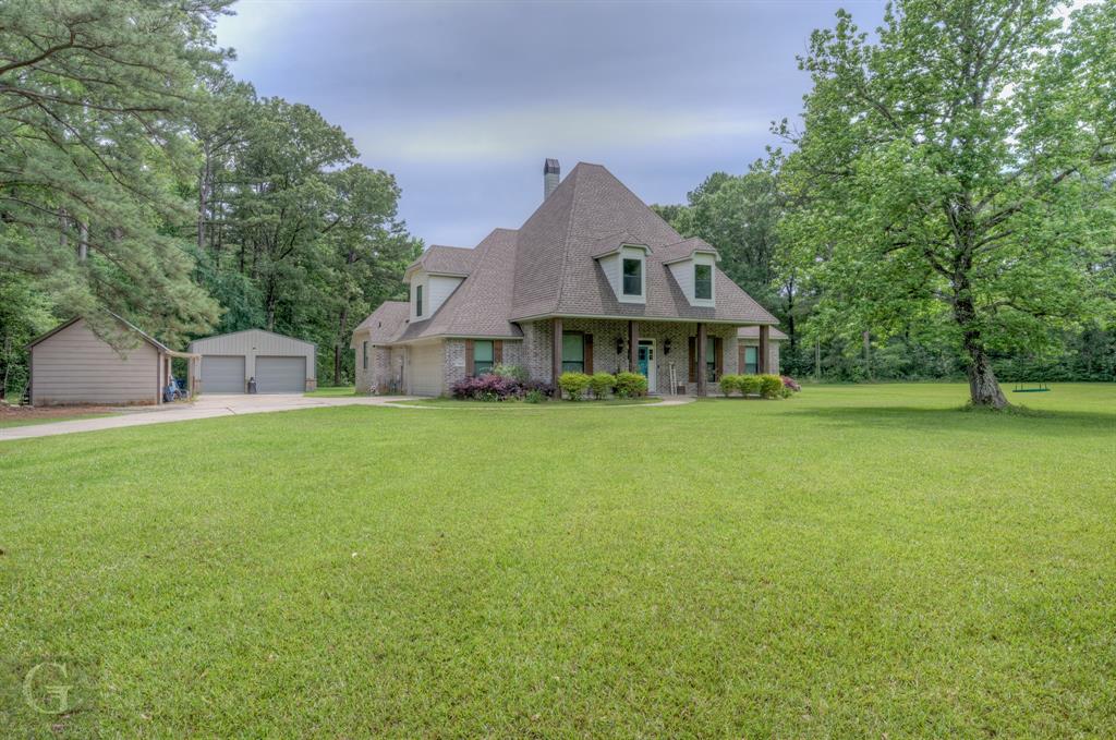 7453 Shirley Francis Road Shreveport, LA 71129 - Photo 2 of 30 a front view of house with yard and trees in the background