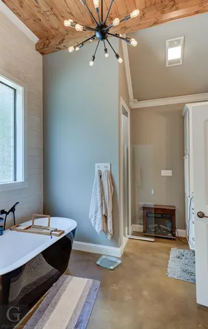 a spacious bathroom with a granite countertop sink a mirror and shower
