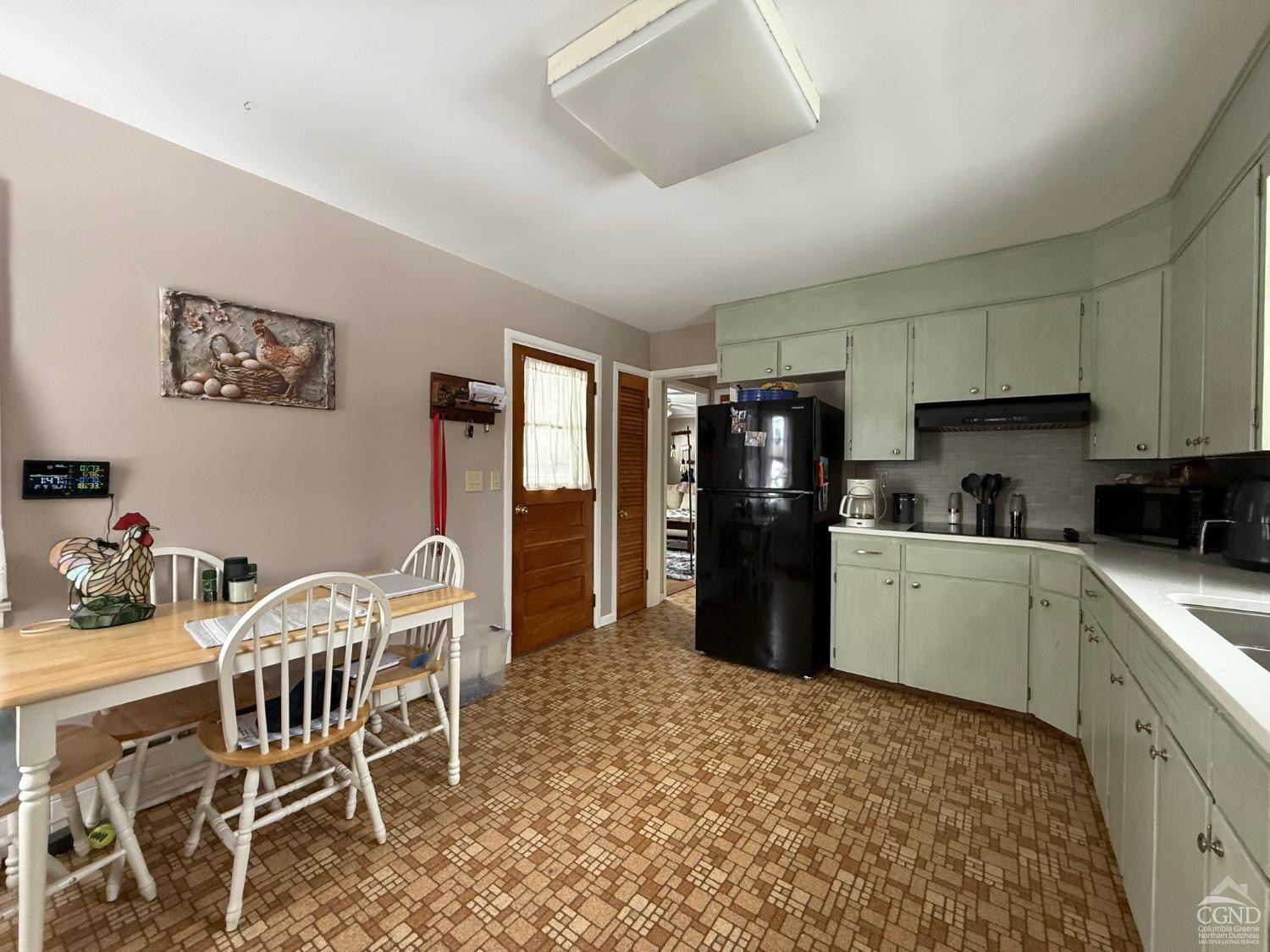 190 Beilke Road Millerton, NY 12546 - Photo 9 of 22 a kitchen with a dining table chairs and refrigerator