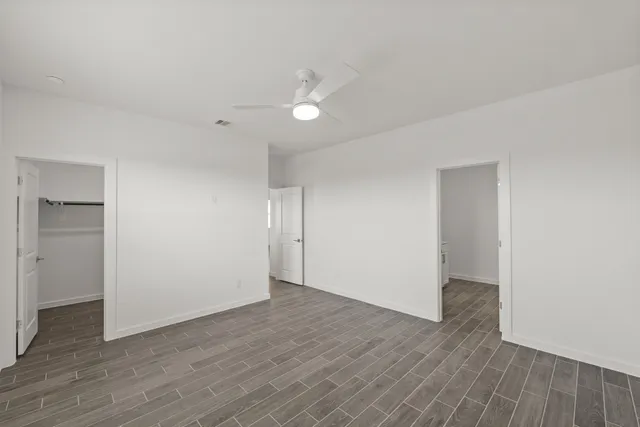 a view of an empty room with wooden floor