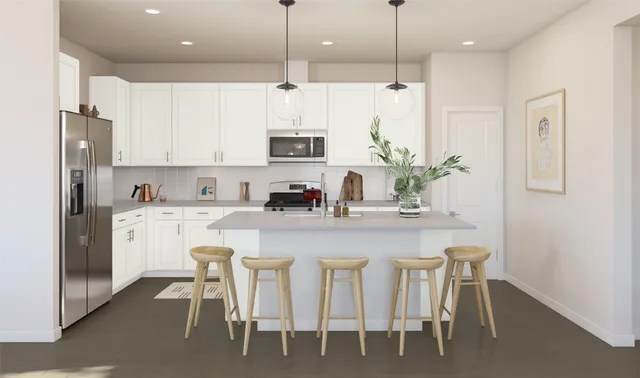 a kitchen with stainless steel appliances granite countertop a table chairs refrigerator and microwave