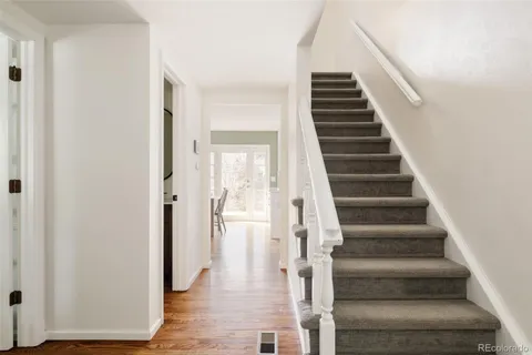 a view of an entryway with wooden floor