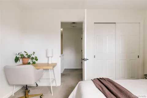 a bedroom with a bed and a table