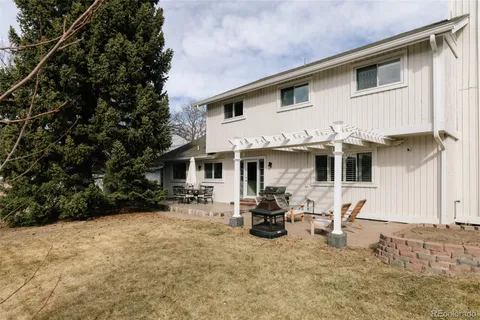 a view of a house with backyard and sitting area