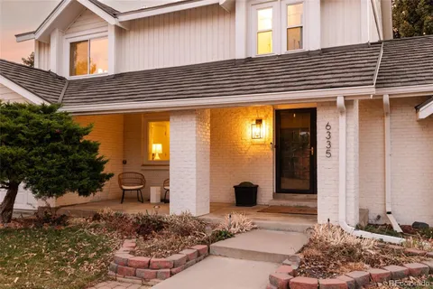 a front view of a house with plants